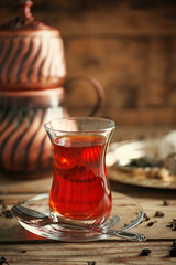 Turkish tea in traditional glass on wooden background