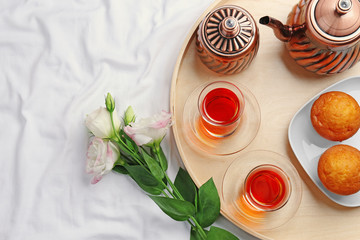Romantic breakfast with tea and cakes on bed