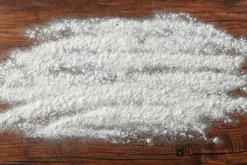 White flour on wooden kitchen table