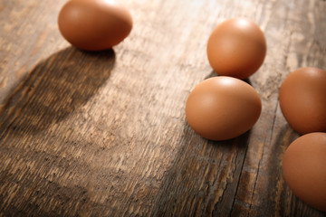 Raw eggs on wooden background