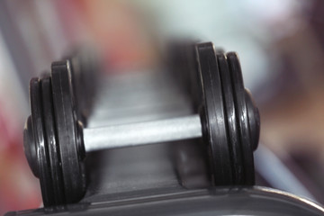 Obraz na płótnie Canvas Rack with different dumbbells in gym, close up