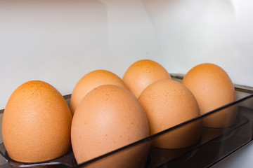 chicken eggs on the shelf of the refrigerator