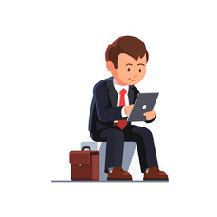 Sitting business man using his tablet computer