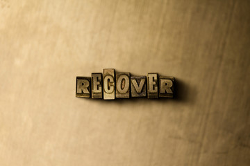 RECOVER - close-up of grungy vintage typeset word on metal backdrop. Royalty free stock - 3D rendered stock image.  Can be used for online banner ads and direct mail.