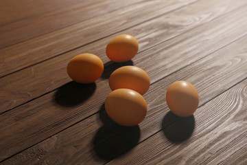 Raw eggs on wooden background