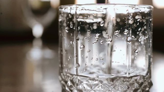 Pouring glass of water, slow motion