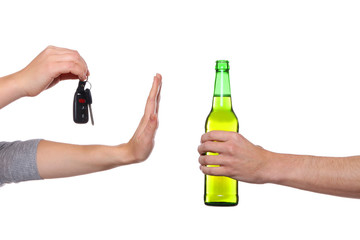 Woman with car key refusing bottle of beer, on white background. Don't drink and drive concept