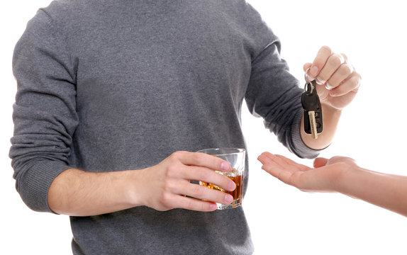 Close up view of drunk man giving car key to woman, on white background. Don't drink and drive concept