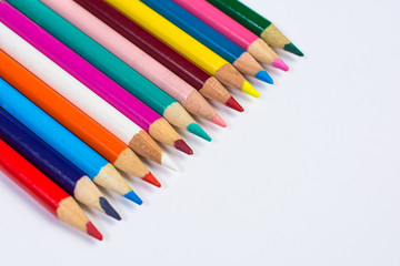 Line of Colored Pencil Crayons Isolated on White Angled View