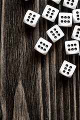 risk concept playing dice at dark wooden background top view
