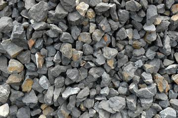 aggregate - a stack of gravel / grit consisting of larger dark and light gray coarse stones,...