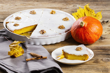 piece of pumpkin cake surrounded by leaves and pumpkin