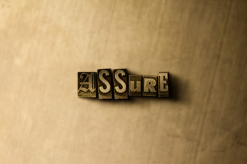 ASSURE - close-up of grungy vintage typeset word on metal backdrop. Royalty free stock - 3D rendered stock image.  Can be used for online banner ads and direct mail.