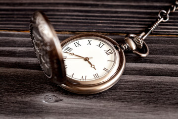 deadline concept pocket watch on wooden background
