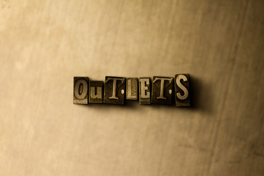 OUTLETS - close-up of grungy vintage typeset word on metal backdrop. Royalty free stock - 3D rendered stock image.  Can be used for online banner ads and direct mail.