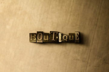 BOUTIQUE - close-up of grungy vintage typeset word on metal backdrop. Royalty free stock - 3D rendered stock image.  Can be used for online banner ads and direct mail.