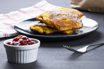 Pumpkin pancakes with marmelade and powdered sugar