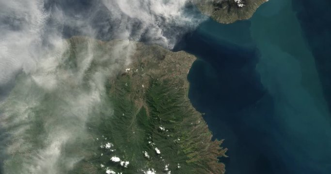 High-altitude overflight aerial of Sangeang Api volcano, near Sumbawa Island, Indonesia. Clip loops and is reversible. Elements of this image furnished by USGS/NASA Landsat