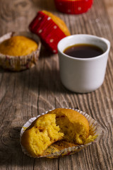 pumpkin muffins and a cup of coffee on a wooden table