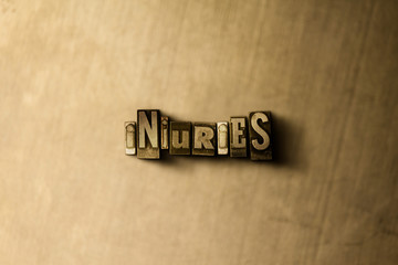 INJURIES - close-up of grungy vintage typeset word on metal backdrop. Royalty free stock - 3D rendered stock image.  Can be used for online banner ads and direct mail.