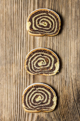 Set of poppy seeds cake slices on a wooden table