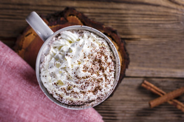 Hot chocolate with whipped cream on a wooden table