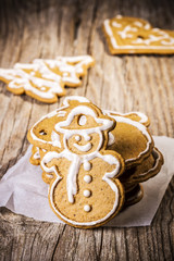 Christmas gingerbreads with lemon glaze on a wooden table
