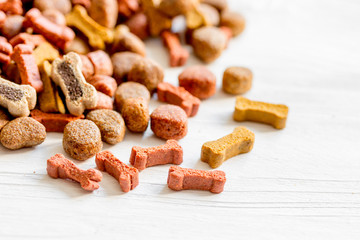 dry dog food in bulk on wooden background close up
