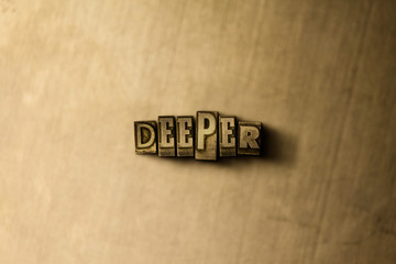 DEEPER - close-up of grungy vintage typeset word on metal backdrop. Royalty free stock - 3D rendered stock image.  Can be used for online banner ads and direct mail.