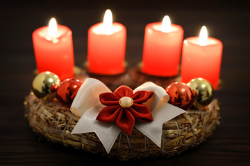 Advent wreath with four burning candles on it. Christmas decoration 