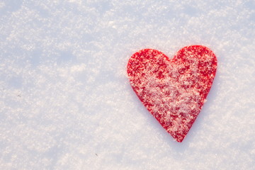 Red felt heart on snow, Valentine's Day. Copy space for text. Snowflakes on heart. Valentines day, love concept. White background