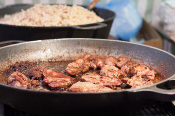 Fried meat in a pan at Christmas market