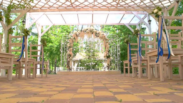 Wedding arch and chairs. Small bouquets with ribbons. Holiday of love and unity.