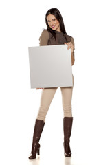 young beautiful woman  holding a blank board for advertisement