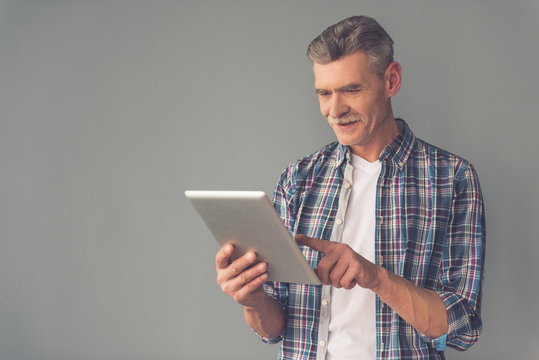 Mature man with gadget