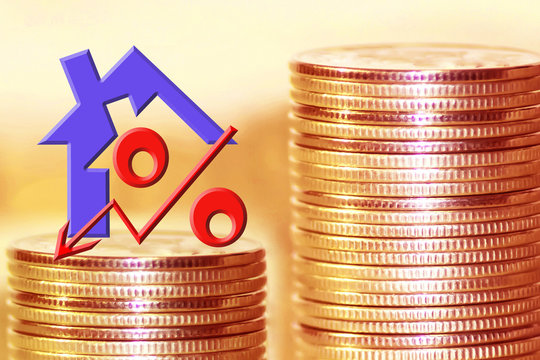 The symbol of the real estate and of percent on the background of money . The concept of changes in the value of the property