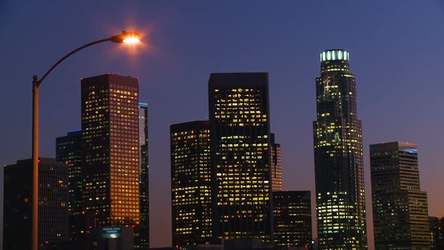 DTLA Skyline Time-lapse. Day to night time lapse view of downtown Los Angeles as the sun sets behind the skyline and the lights in the windows begin to black out.