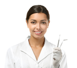 Young female dentist wearing in uniform and holding medical equipment isolated on white