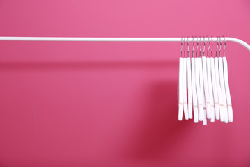 Modern hangers on pink wall background