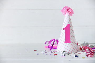 Birthday party cap on wooden background
