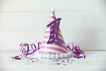 Birthday party cap on wooden background