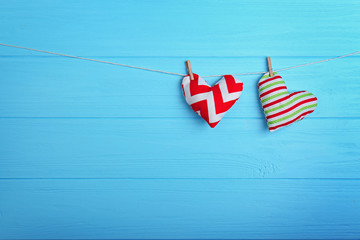 Small soft hearts hanging on wooden background