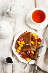 Crepes with fresh mango and raspberries