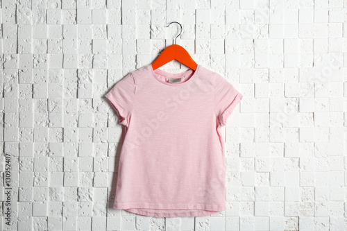 “Blank pink t-shirt against light textured background” Stock photo and