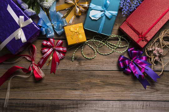 Colorful gift boxes on wooden table, top view