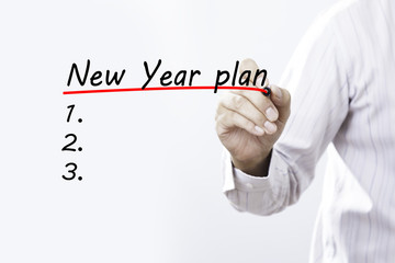 Businessman hand writing New year plan with red marker on transp
