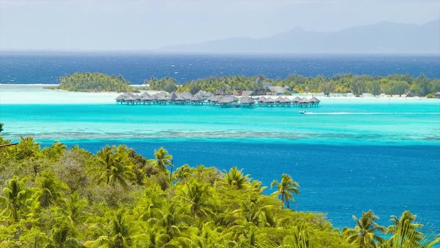 Bora Bora Tropical Medium Lagoon Scene with Over Water Bungalows on Exotic Luxury Resorts Shades of Blue Water and Green Foliage