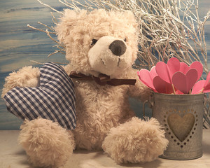 A teddy bear and  heart. Teddy bear as a gift for Valentine. Happy Valentines day - vintage style - soft focus
