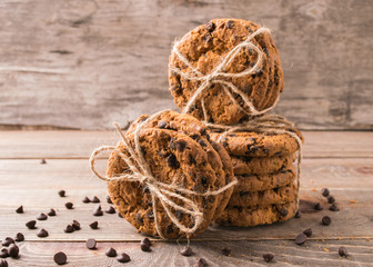 Homemade oatmeal cookies tied with a rope lying in stacks on a d