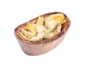 Food of love, marinated artichokes in olive wood bowl isolated on white background